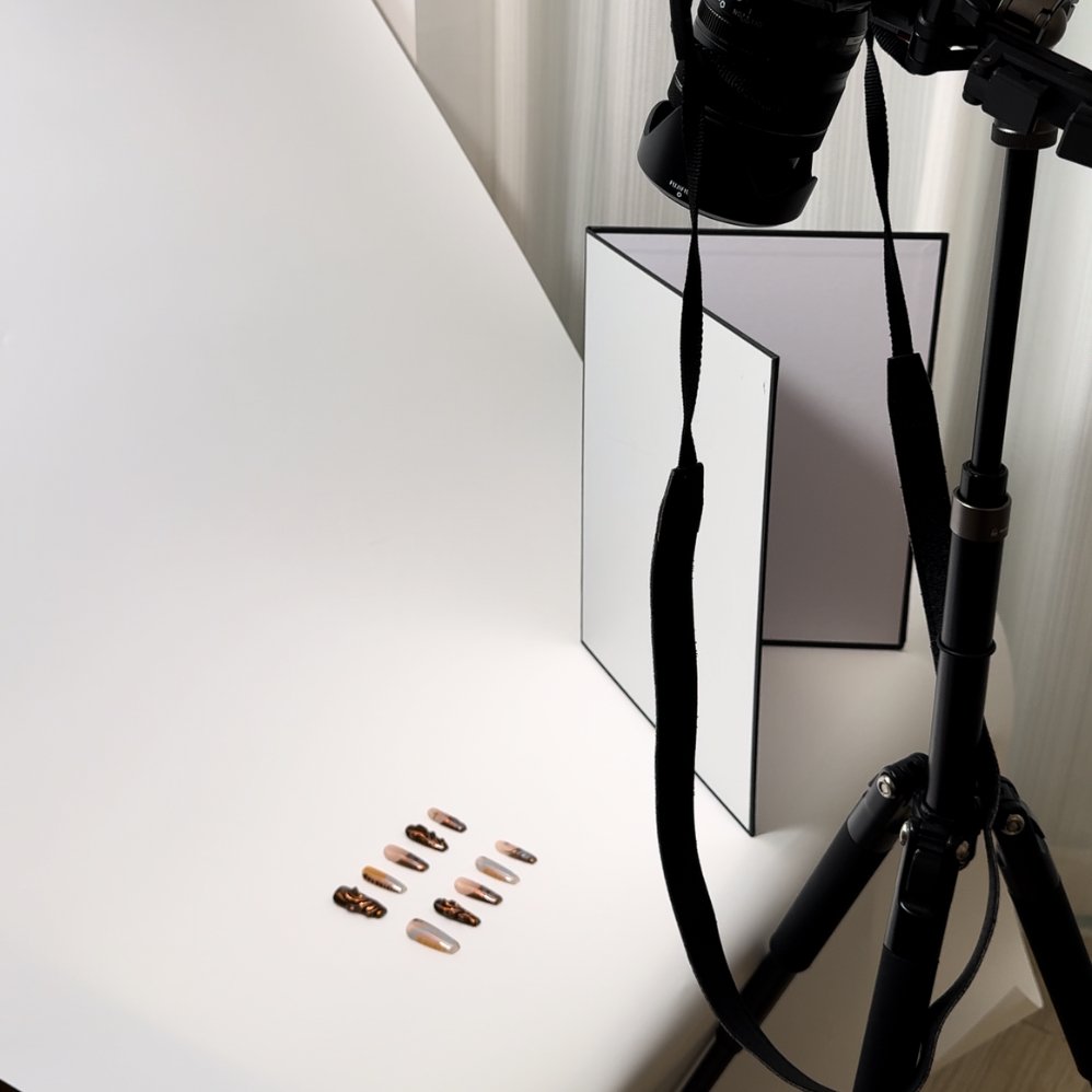 A close-up of a Snaps Chic press-on nail being photographed, demonstrating commitment to authentic and detailed product representation.