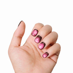 Hand model showcasing Burgundy Cat Eye Glam press-on nails from Snaps Chic