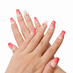 Hand model showcasing Juciy Peach press-on Nails from Snaps Chic