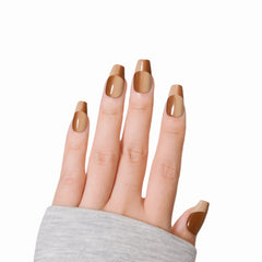 Hand model showcasing Khaki Illusion press-on nails from Snaps Chic